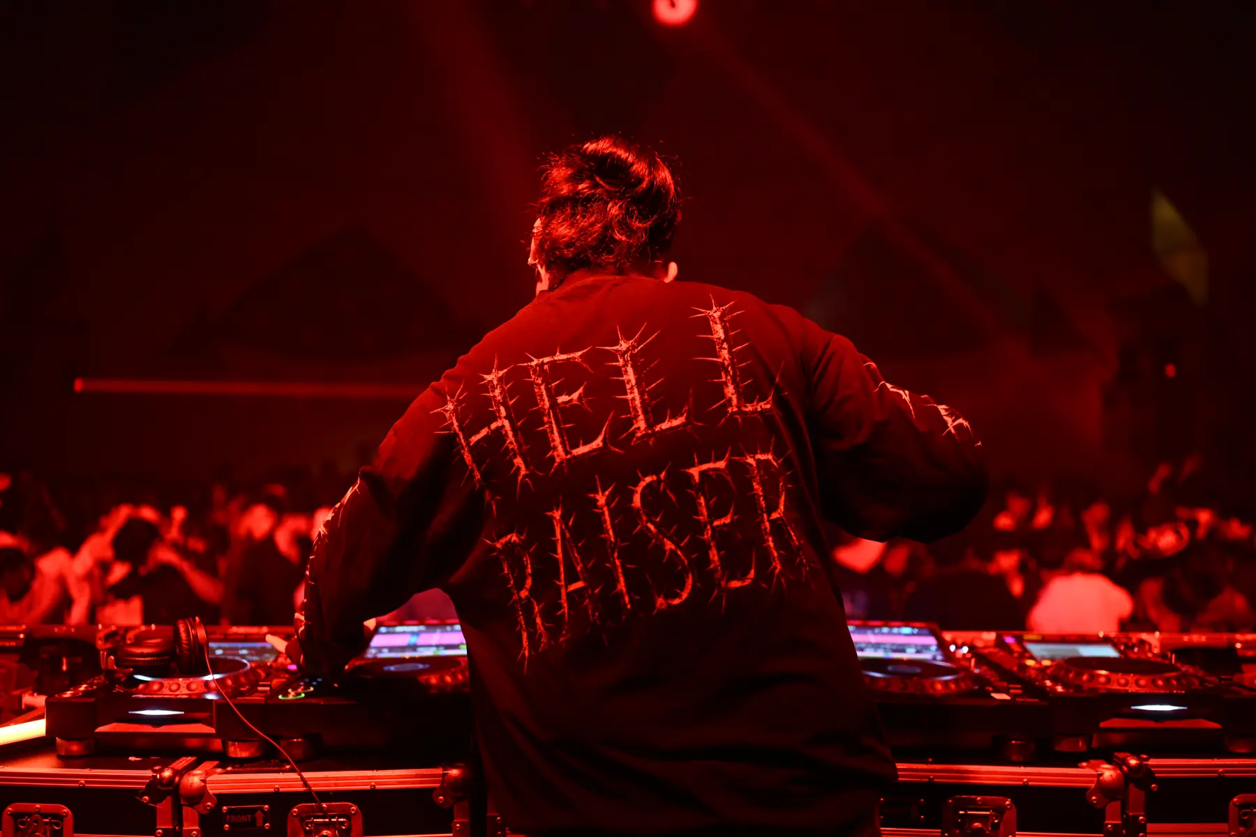 DJ in front of the crowd at the Kamikaze event